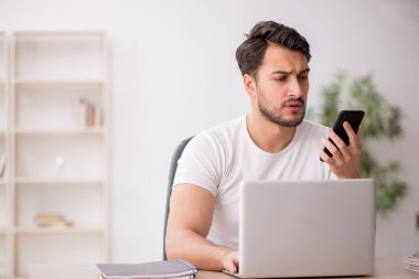 Genç çalışan işyerinde oturuyor.