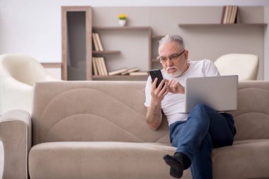 Old man sitting at home during pandemic