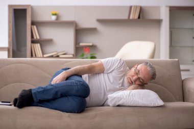 Old man sitting at home during pandemic