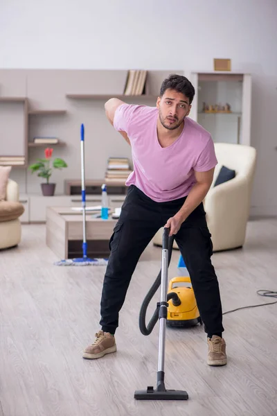 Young contractor cleaning the house