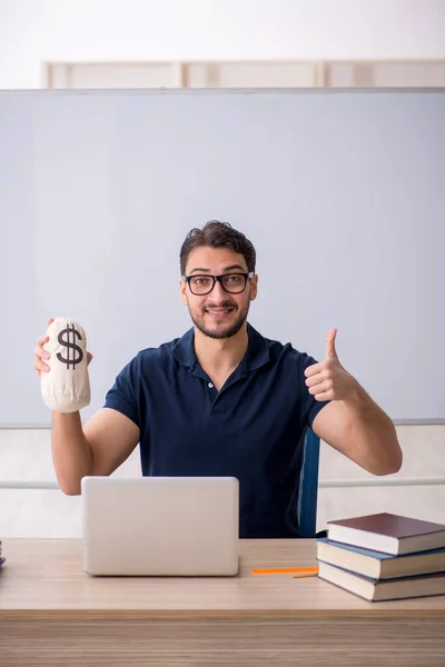 Young Teacher Holding Moneybag Classroom — Stock Photo, Image