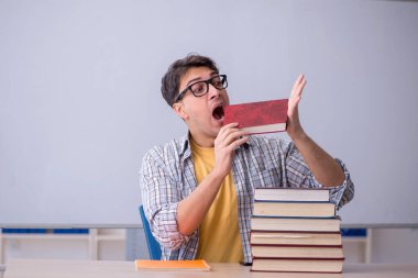 Sınıfta sınava hazırlanan genç bir öğrenci.