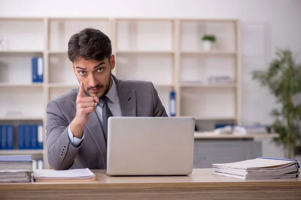 stock image Young employee working at workplace