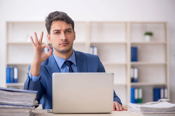 stock image Young employee working at workplace