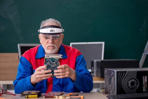 Sınıfta Bilgisayar Tamir Eden Yaşlı Bir Erkek Tamirci — Stok fotoğraf