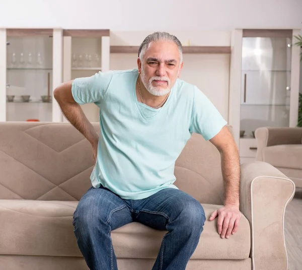 stock image The white bearded old man suffering at home