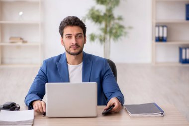 Genç çalışan işyerinde oturuyor.