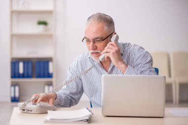 Old employee working at workplace