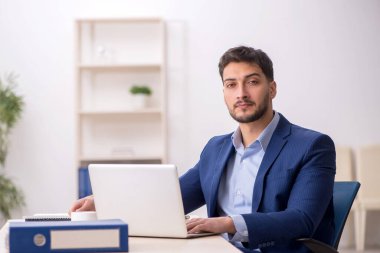 Genç çalışan işyerinde oturuyor.