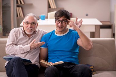 Young student and his grandfather at home