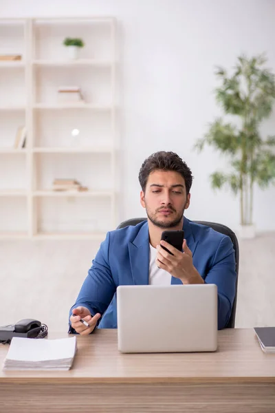 stock image Young employee sitting at workplace