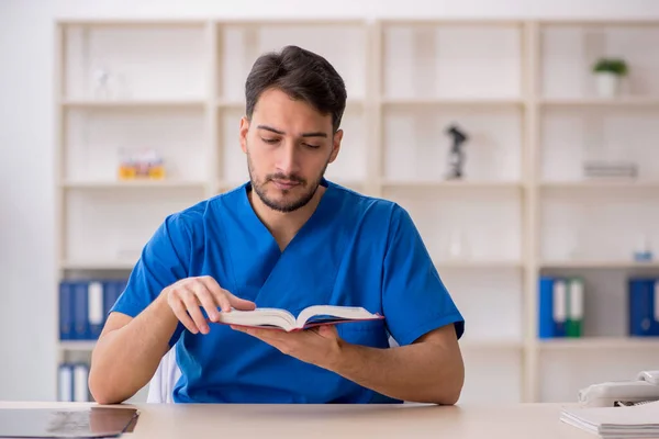 Young doctor student reading book