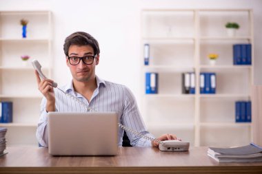 Genç işadamı ve işyerinde çok fazla iş var.