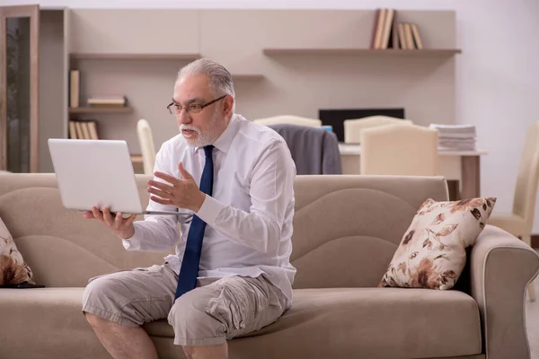 Old businessman employee working from home during pandemic