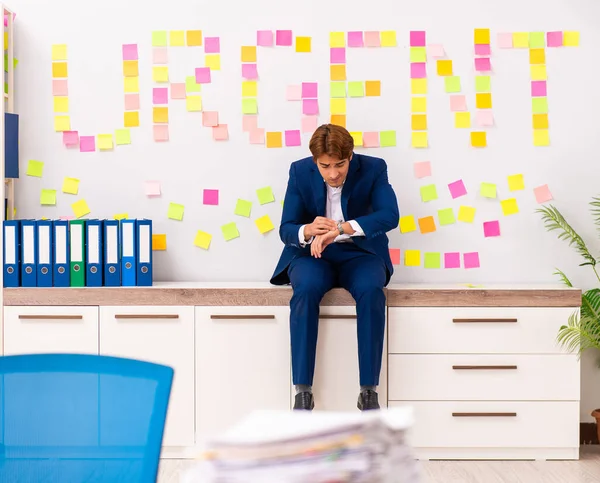 stock image The young employee suffering from excessive work