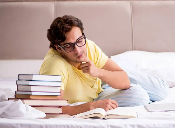 Νεαρός Φοιτητής Που Σπουδάζει Στο Κρεβάτι Για Εξετάσεις — Φωτογραφία Αρχείου