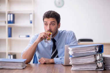 Young businessman employee feeling bad in the office