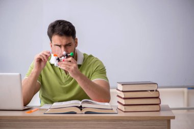 Young student physicist sitting in the classroom