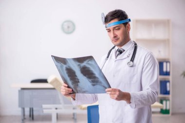 Young doctor otolaryngologist working at the hospital