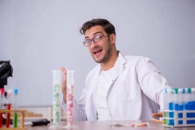 Young chemist in front of white board