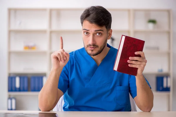 Young doctor student reading book