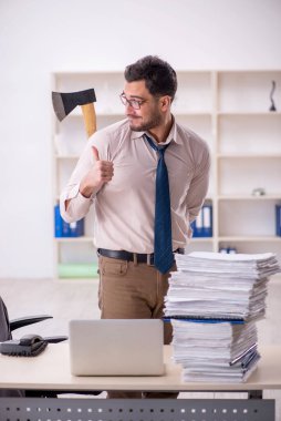 Young employee and too much work at workplace