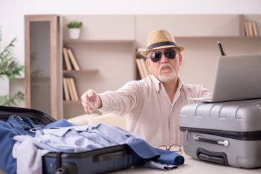 Aged man preparing for trip at home