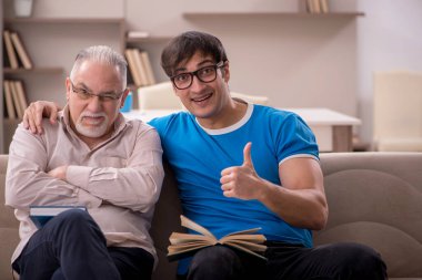 Young student and his grandfather at home