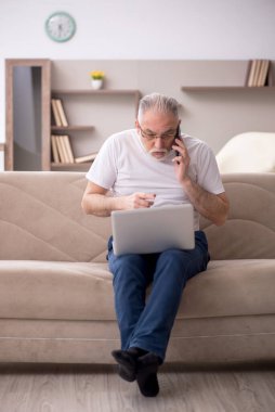 Old man sitting at home during pandemic