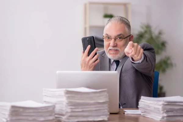 stock image Old employee and too much work at workplace