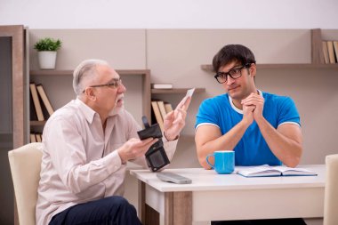 Young student and his grandfather at home