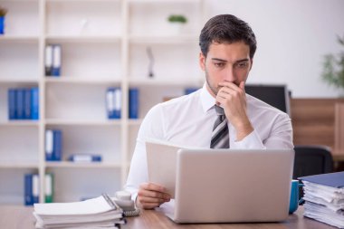 Genç işadamı ofisteki aşırı işten memnun değil.