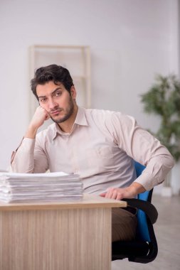 Young accountant sitting at workplace