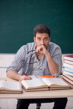 Young teacher suffering in the classroom