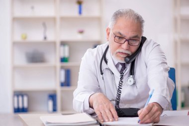 Teletıp konseptinde yaşlı bir doktor.