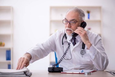 Teletıp konseptinde yaşlı bir doktor.