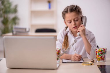 Little girl playing doctor in telemedicine concept