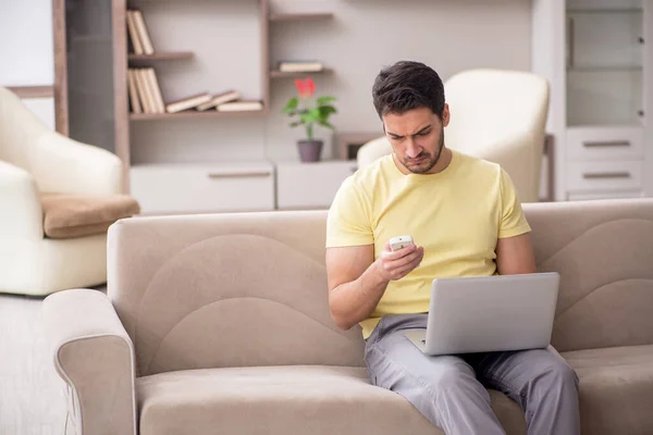 stock image Young male student watching tv at home