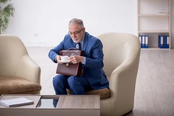 stock image Old male boss waiting for business meeting