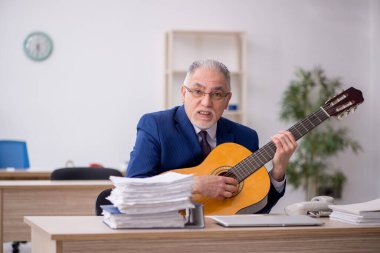 Old employee playing guitar in the office