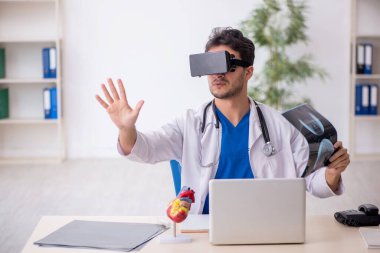 Genç doktor klinikte sanal gözlüklerin keyfini çıkarıyor.