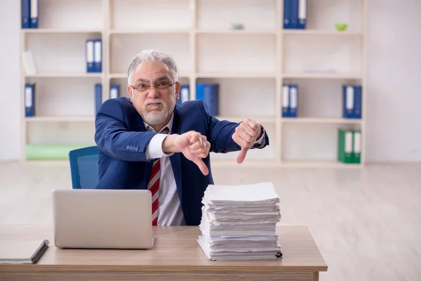 stock image Old employee unhappy with excessive work at workplace