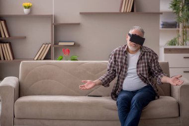 Old man enjoying virtual glasses at home