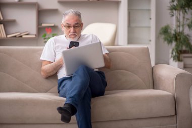 Old man sitting at home during pandemic