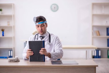 Young doctor otolaryngologist working at the hospital