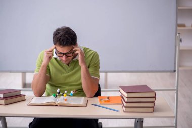 Young student physicist sitting in the classroom