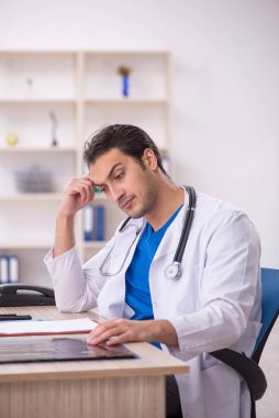 Hastanede çalışan genç erkek doktor.