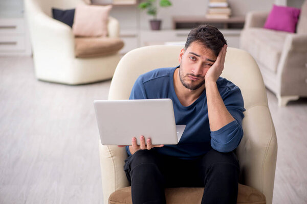 Young male student working from home during pandemic