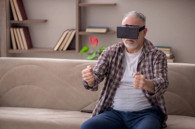 Old man enjoying virtual glasses at home