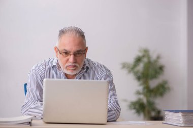 Old employee working at workplace